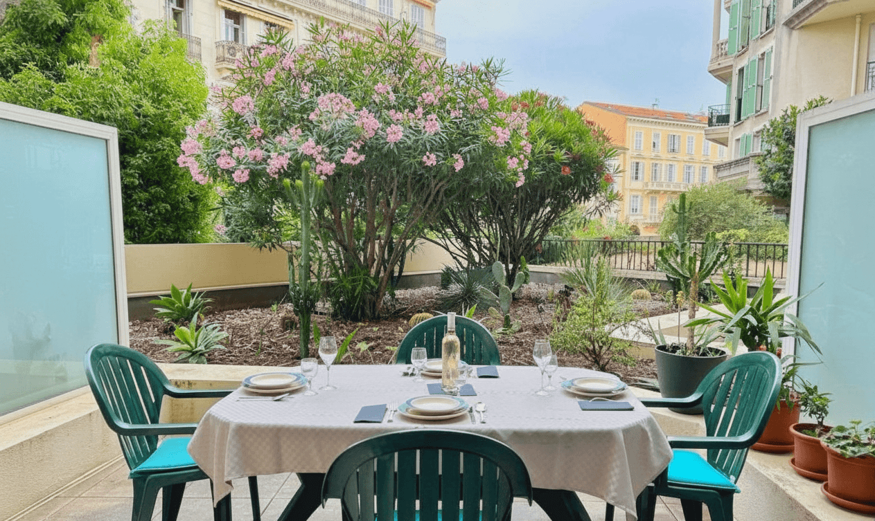 Private terrace with outdoor dining table and garden view in central Menton
